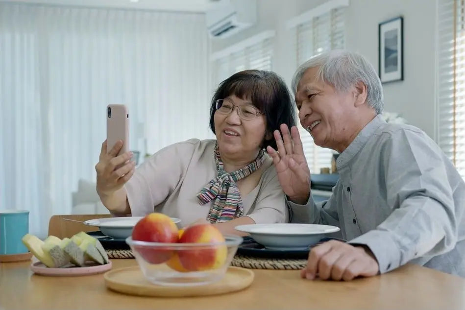 Independent parents at home on a video call with family.